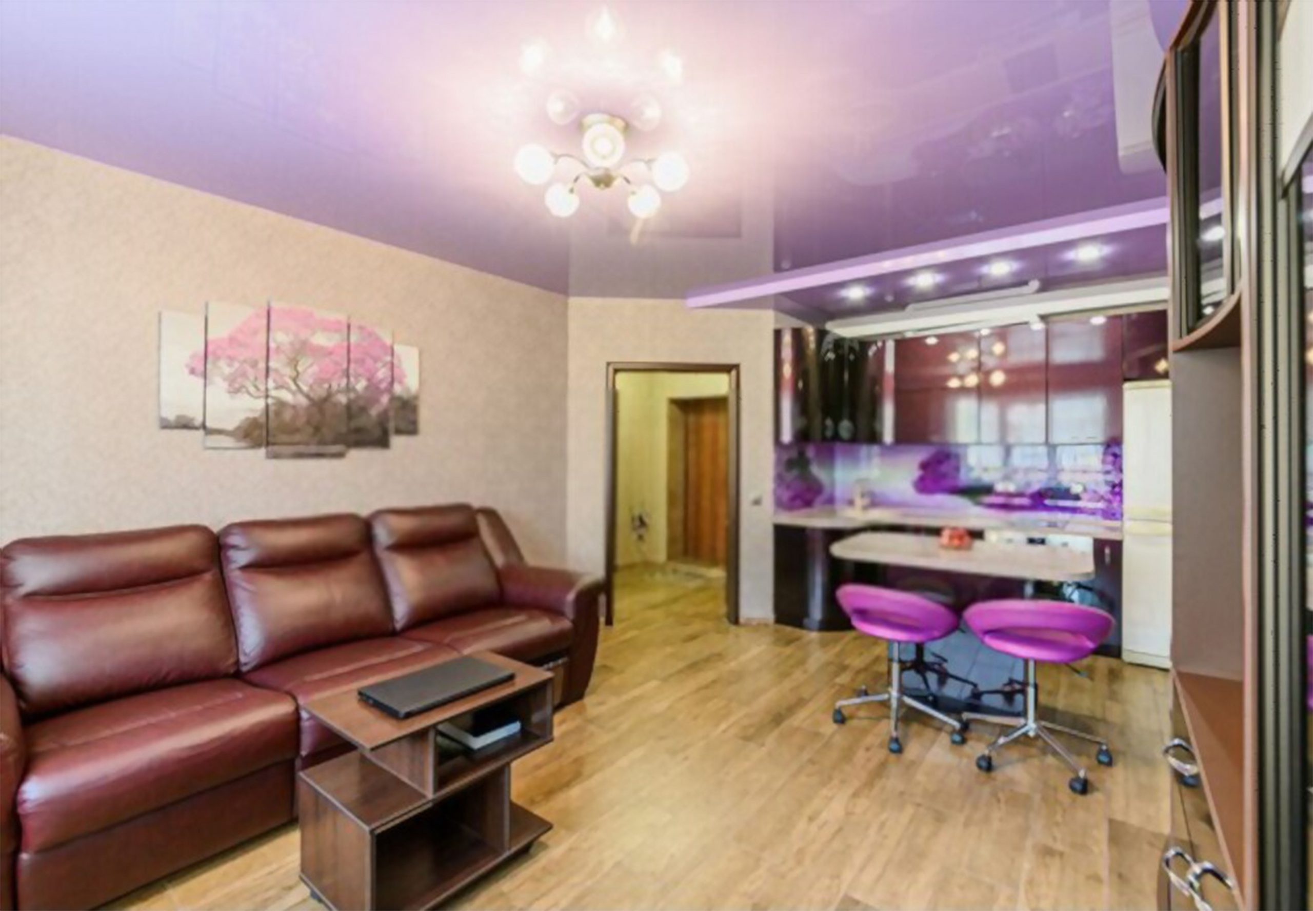 "Image of a small office with a purple lacquer stretch ceiling. The glossy surface adds a touch of modernity and elegance to the space. Contemporary furniture and efficient use of space create a productive and stylish work environment."